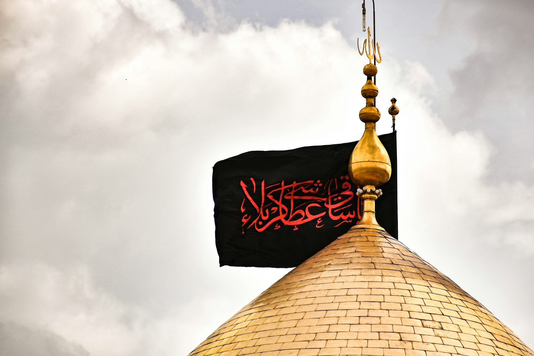 Golden shrine dome with black flag